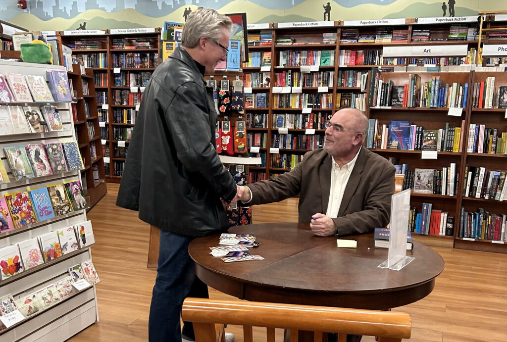 Author greeting a reader at a bookstore event